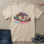Beige t-shirt with a cat graphic and 'Paws & Relax' text on a beige background